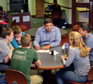 Professor and students engaged in a discussion.